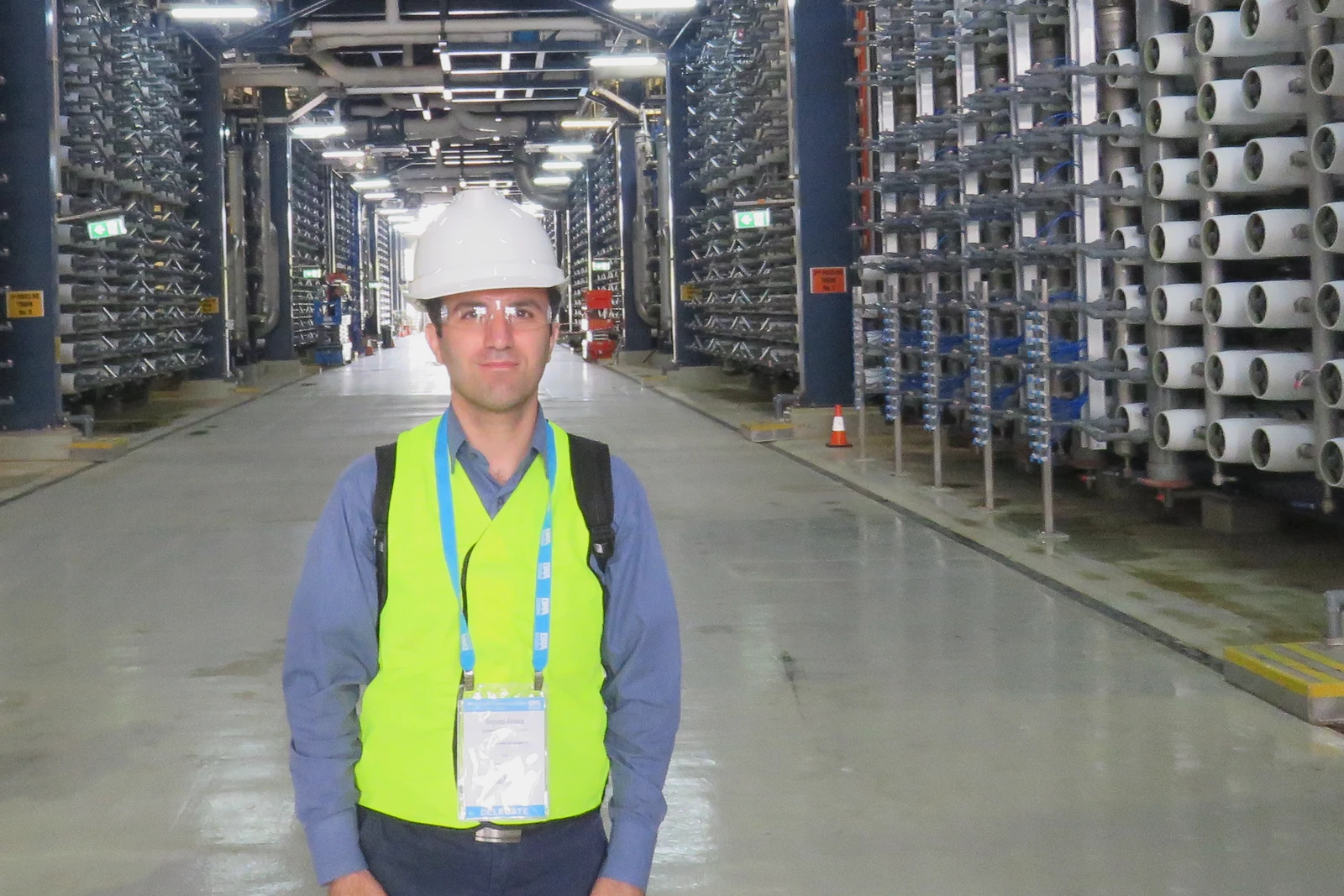 Seyyed Alireza Ebrahimzadeh Zonouzian wearing a safety helmet and high-visibility vest during a technical site visit
